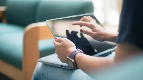 Student using laptop as tablet