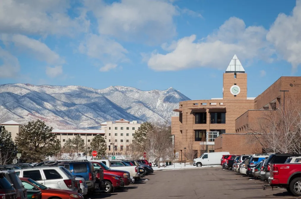 Snowy UCCS parking lot in view of the clock tower.